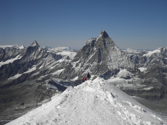 Summit ridge of Breithorn with the Matterhorn in the distance.